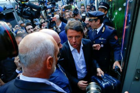 Italy's Former Prime Minister Matteo Renzi arrives to board a train during his electoral tour