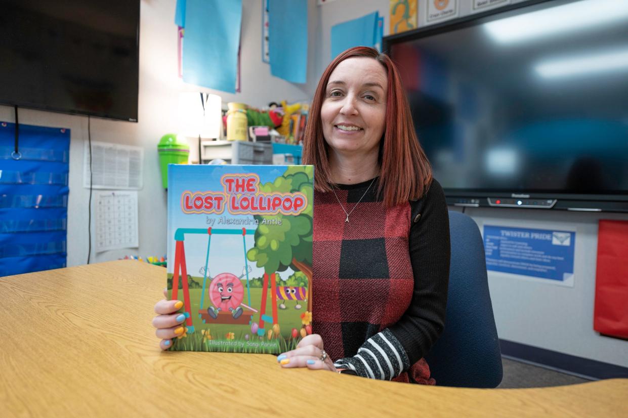 Alexandria Antle holds a copy of her recently published children's book "The Lost Lollipop" on March 29.