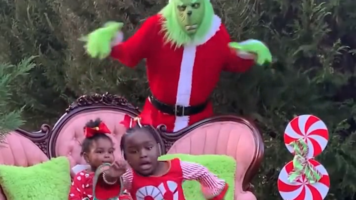 The Grinch scares little girls posing for picture