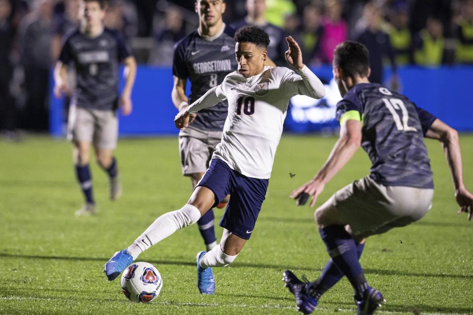 Virginia's Nathaniel Crofts (10) handles the ball ahead of Georgetown's Dylan Nealis (12) during the second half of the NCAA college soccer championship in Cary, N.C., Sunday, Dec. 15, 2019. (AP Photo/Ben McKeown)