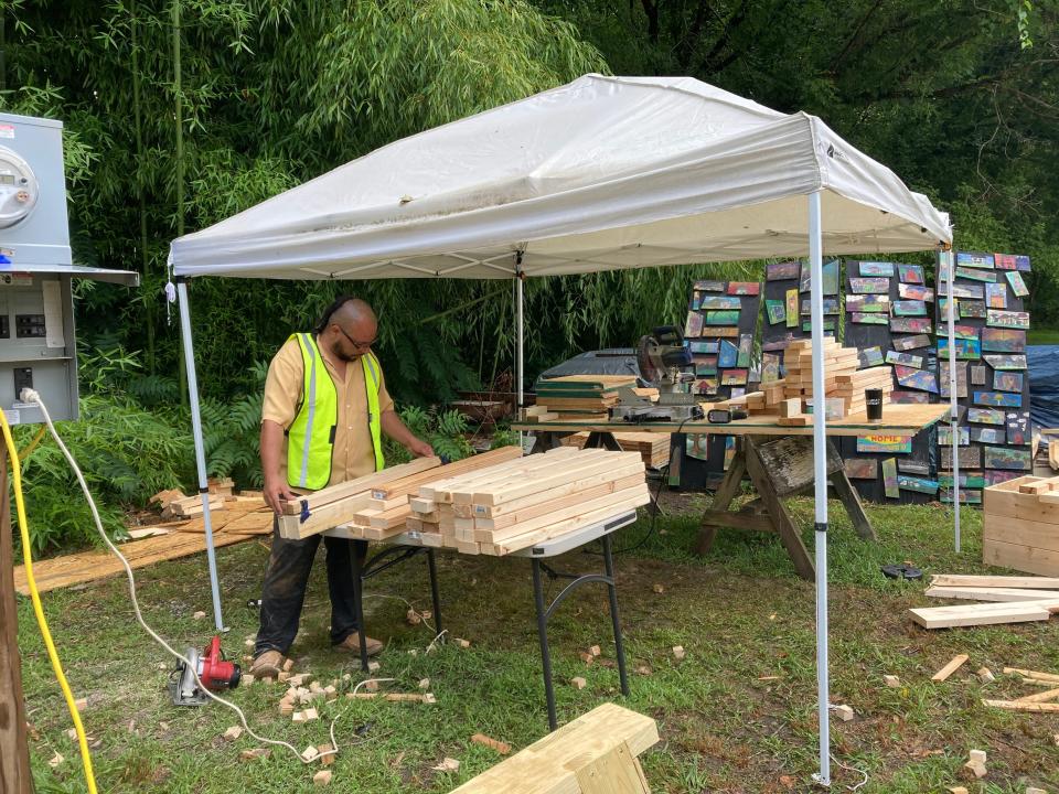 BeLoved co-director Ponkho Bermejo on site in East Asheville in July 2022 where the nonprofit and volunteers are working to build 12 microhomes.