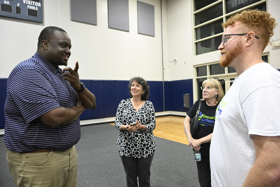 Genesis Robinson, interim executive director of Equal Ground Education Fund and Action Fund, from left, chats with Rosemarie Latham, Donna Cochran and David Bagley during the Voters Education 2024 Community Forum, addressing the Florida Legislature's voter suppression tactics, Thursday, May 16, 2024, in Daytona Beach, Fla. Laws passed in several Republican-controlled states are making it challenging for advocates to adapt as they try to register and educate potential voters with just months to go before the presidential election. (AP Photo/Phelan M. Ebenhack)