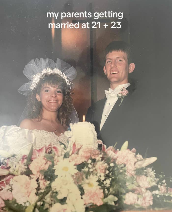 Wedding photo of a couple with the bride in a white gown with a veil and the groom in a black suit with a bow tie