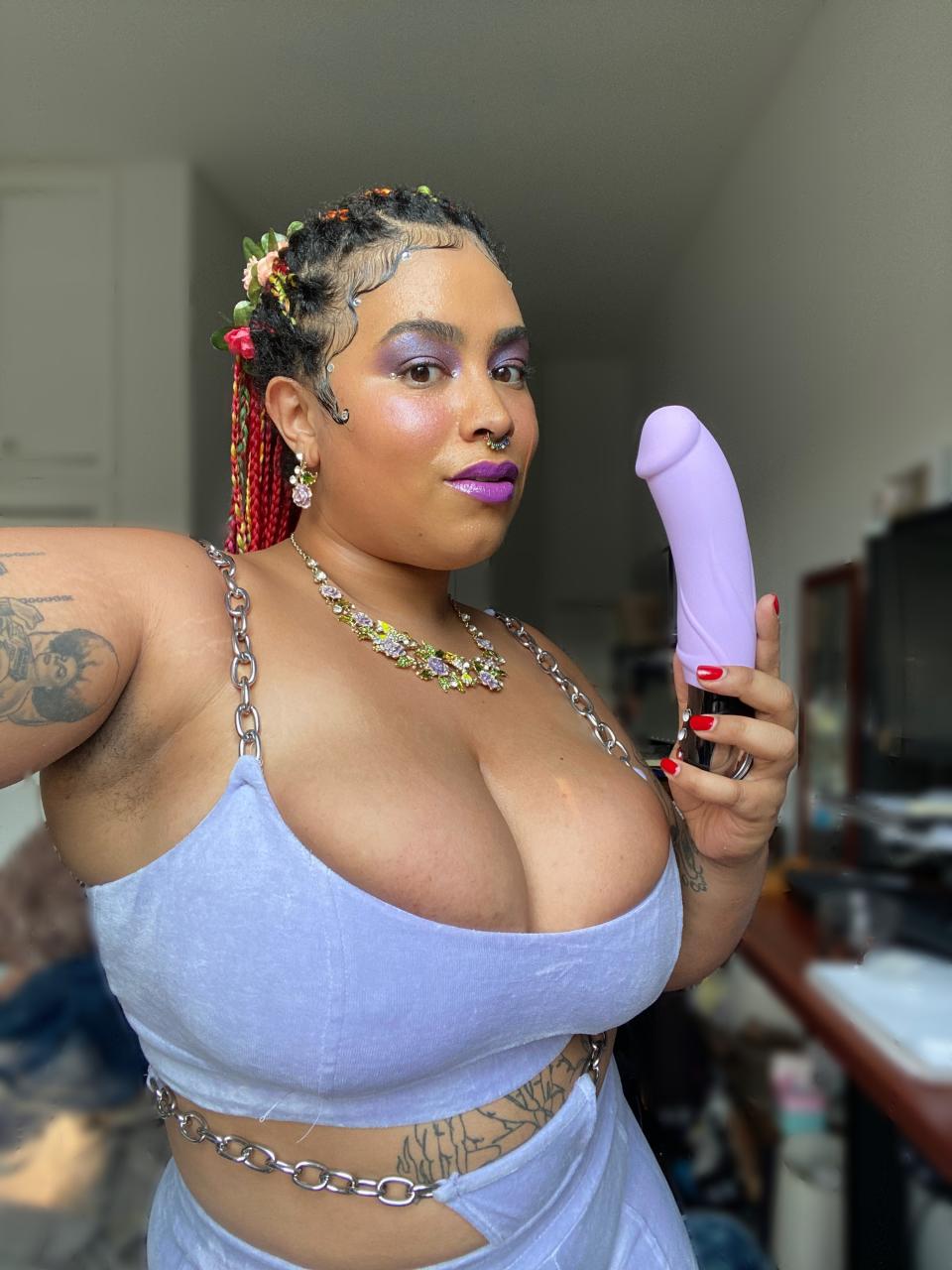 Woman holding pastel purple vibrating dildo