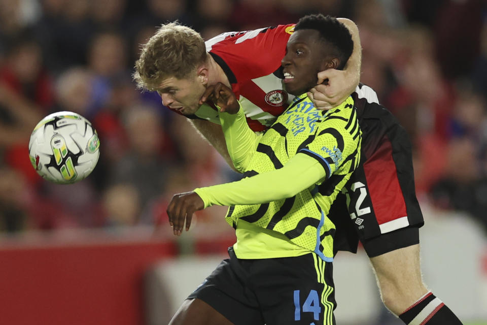 Arsenal's Eddie Nketiah, left, challenges for the ball with Brentford's Nathan Collins during the English League Cup third round soccer match between Brentford and Arsenal at the Gtech Community Stadium, in London Wednesday, Sept. 27, 2023. (AP Photo/Ian Walton)