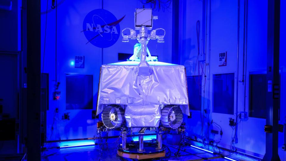  A four-wheeled robot in a cleanroom under UV lights. 