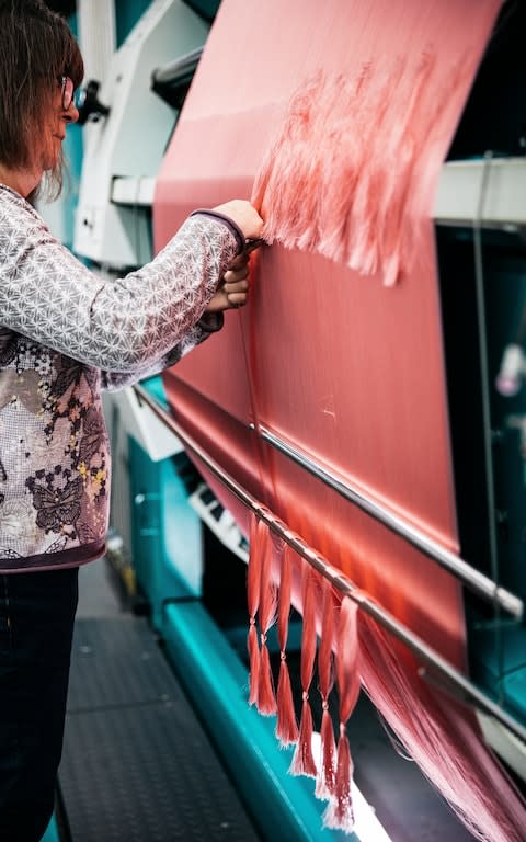 Threads are checked as they process through the looms - Credit: George Baxter