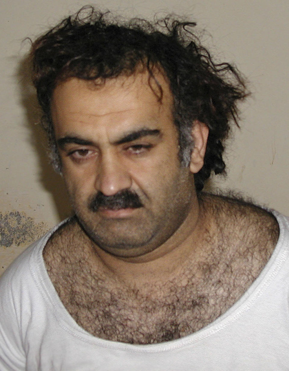 FILE -In this March 1, 2003 file photo, Khalid Sheikh Mohammed is seen shortly after his capture during a raid in Pakistan. Responding to an inquiry by Sulaiman Abu Ghaith’s attorney, the architect of the September 11, 2001, terrorist attacks on the United States still boasts that the Taliban was good for Afghanistan and a leader among Muslim-led governments plus everything Osama bin Laden said was right. Mohammed is being detained at Guantanamo Bay, Cuba and Abu Ghaith is being tried at Federal Court in New York for conspiring to kill Americans. (AP Photo, File)