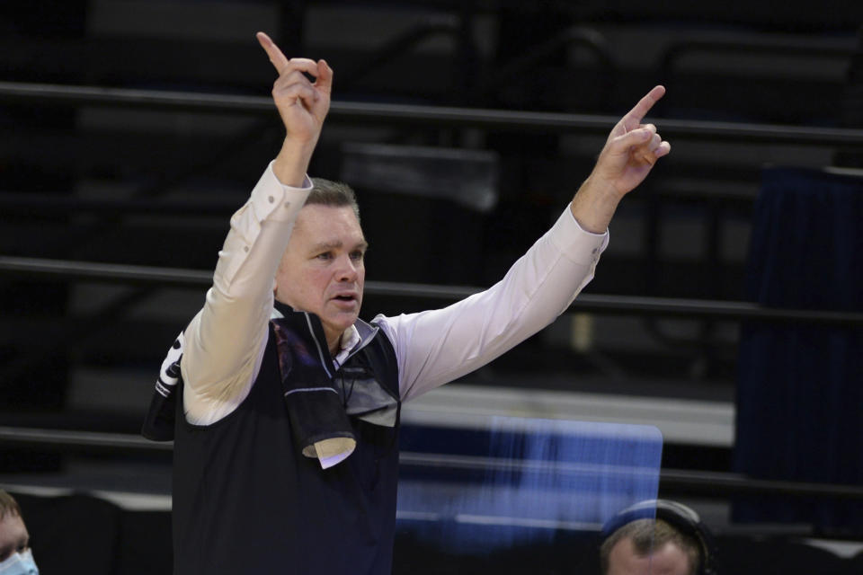 FILE - In this Feb. 18, 2021, file photo, Ohio State coach Chris Holtmann gives instructions to his team late in the second half against Penn State in an NCAA college basketball game in State College, Pa. Ohio State opens on Nov. 9 against Akron, welcoming back fans to Value City Arena for the first time since 2019. (AP Photo/Gary M. Baranec, File)