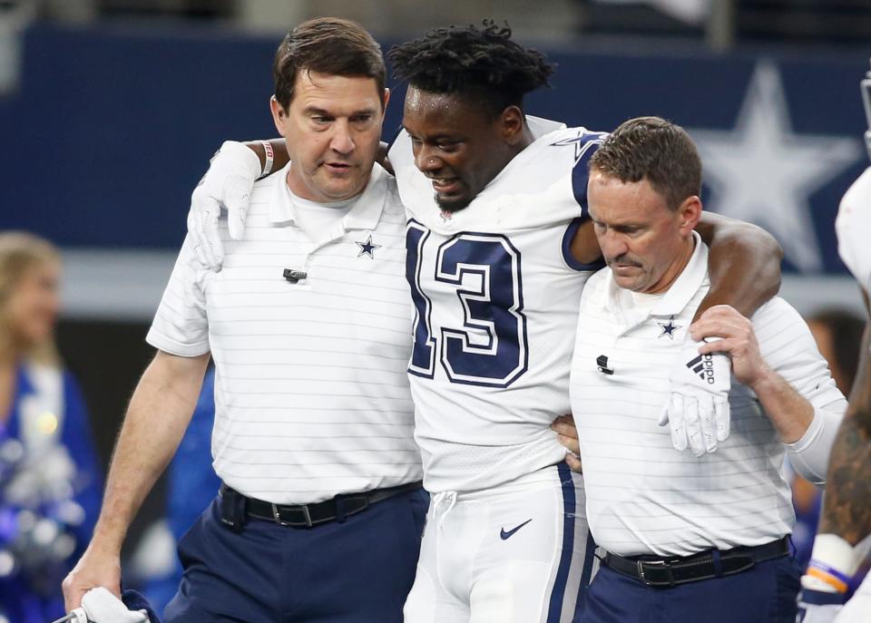 Dallas Cowboys wide receiver Michael Gallup (13) is helped off the field after an injury in the second quarter against the Arizona Cardinals at AT&T Stadium.