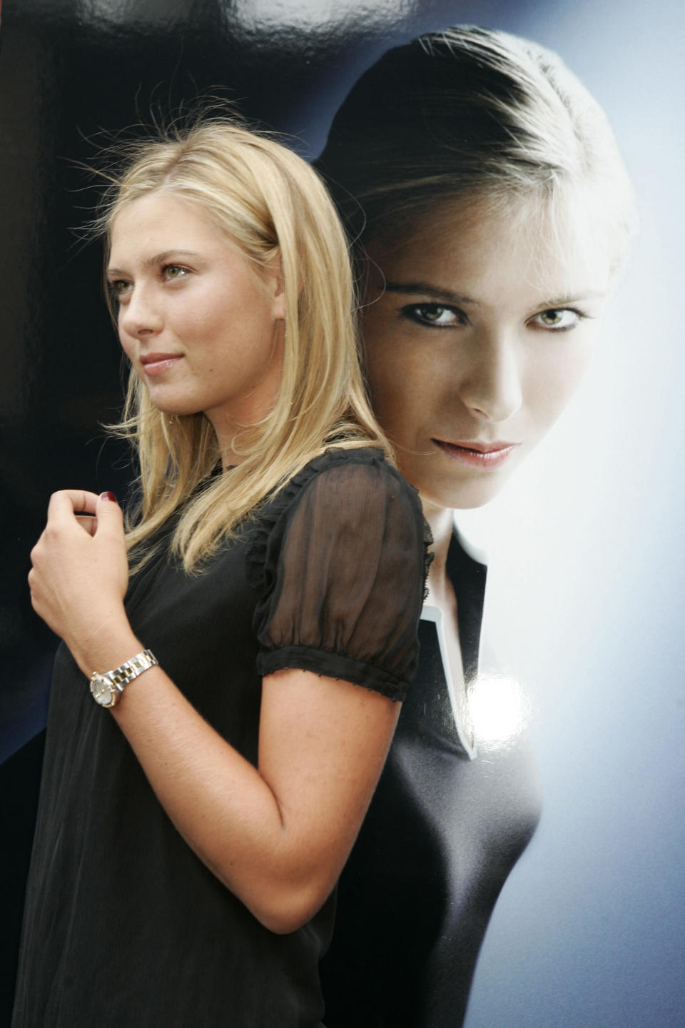 FILE - In this Aug. 22, 2006, file photo, tennis star Maria Sharapova poses with her new TAG Heuer watch outside Bloomingdale's in New York. Sharapova is retiring from professional tennis at the age of 32 after five Grand Slam titles and time ranked No. 1. She has been dealing with shoulder problems for years. In an essay written for Vanity Fair and Vogue about her decision to walk away from the sport, posted online Wednesday, Feb. 26, 2020, Sharapova asks: “How do you leave behind the only life you’ve ever known?” (AP Photo/Diane Bondareff, File)