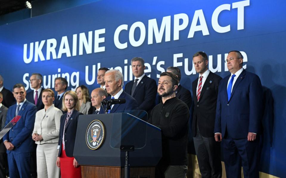 US President Joe Biden listens to Ukraine's President Volodymyr Zelensky at the Washington, DC Nato summit