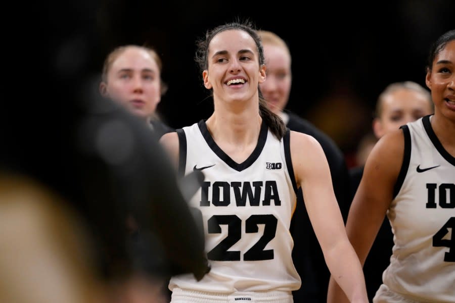 Iowa guard Caitlin Clark (22) heads to the bench for a timeout after breaking the NCAA women’s career scoring record during the first half of the team’s college basketball game against Michigan, Thursday, Feb. 15, 2024, in Iowa City, Iowa. (AP Photo/Matthew Putney)