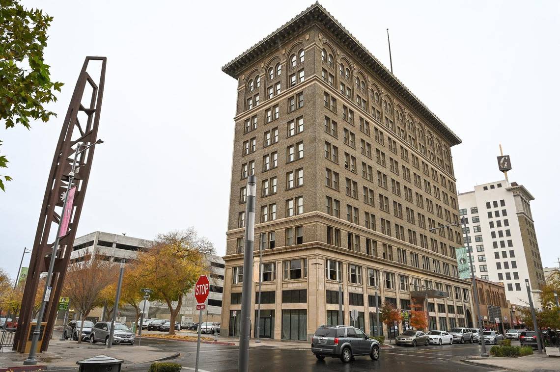 The historic Helm Building is seen between the Fulton Clock Tower in Mariposa Plaza and the Guarantee Savings Building in downtown Fresno on Thursday, Dec. 1, 2022. The Helm Building is Fresno’s first high-rise building but has not had residents in the upper floors since 1995. Developer Sevak Khatchadourian, who has successfully renovated the Pacific Southwest Building, is hoping to change that.