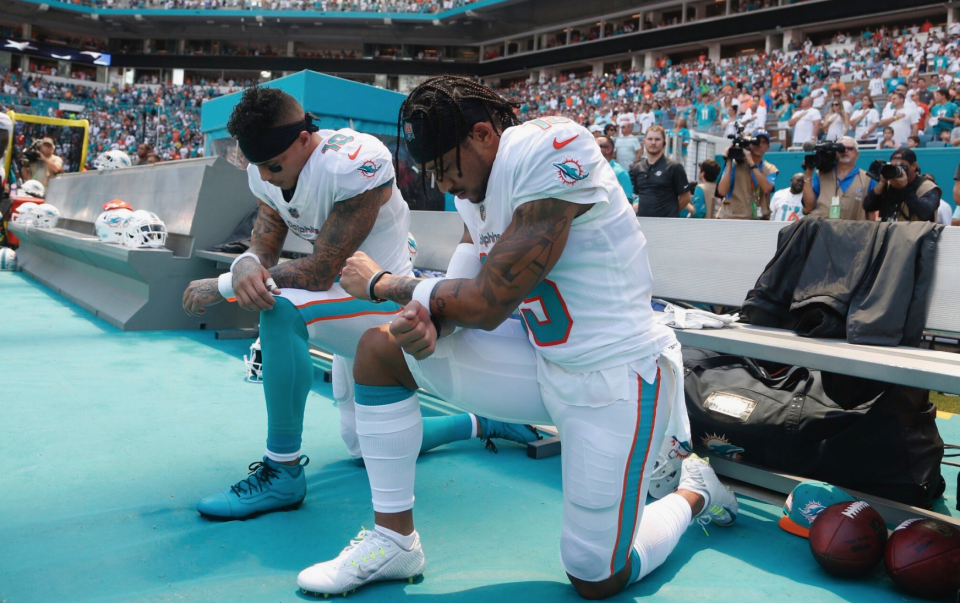 Two Dolphins knelt during the anthem. (Getty)