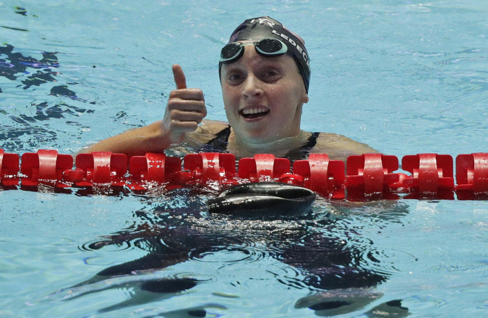 Katie Ledecky gives a thumbs up in the pool after a race.