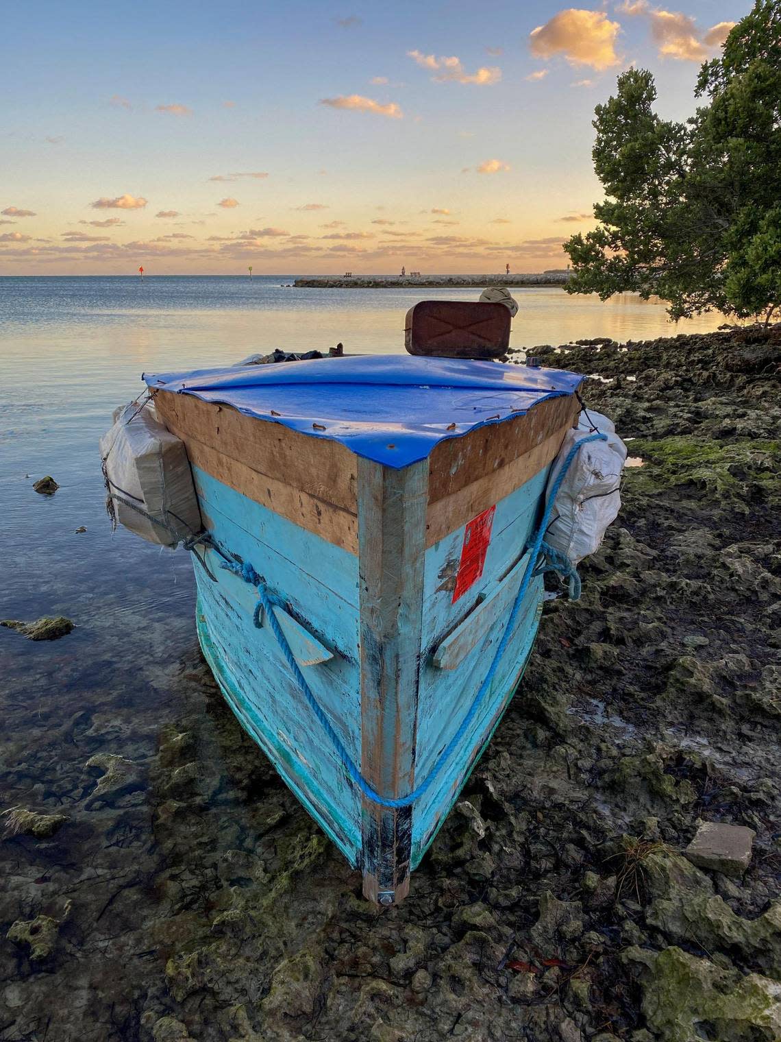A boat used by Cuban migrants to reach the United States sits offshore at Harry Harris Park in Tavernier in the Florida Keys on Jan. 14, 2023.