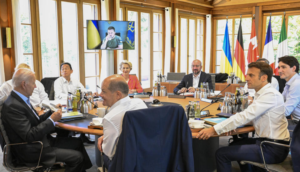 From front center clockwise, Germany's Chancellor Olaf Scholz, US President Joe Biden, Britain's Prime Minister Boris Johnson, Japan's Prime Minister Fumio Kishida, European Commission President Ursula von der Leyen, European Council President Charles Michel, Italy's Prime Minister Mario Draghi, Canada's Prime Minister Justin Trudeau and France's President Emmanuel Macron have taken seat at a round table as Ukraine's President Volodymyr Zelensky addresses the G7 leaders via video link during their working session at Castle Elmau in Kruen, near Garmisch-Partenkirchen, Germany, on Monday, June 27, 2022. The Group of Seven leading economic powers are meeting in Germany for their annual gathering Sunday through Tuesday. (Tobias Schwarz/Pool Photo via AP)