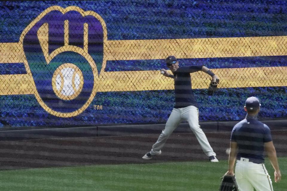 Milwaukee Brewers' Christian Yelich throws during a practice session Monday, July 13, 2020, at Miller Park in Milwaukee. (AP Photo/Morry Gash)