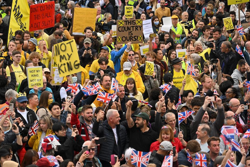 TOPSHOT - Anti-royal protestors hold up placards saying 'Not My King' as they demonstrate behind well-wishers in Trafalgar Square close to where Britain's King Charles III and Britain's Camilla, Queen Consort will be crowned at Westminster Abbey in central London on May 6, 2023. - The set-piece coronation is the first in Britain in 70 years, and only the second in history to be televised. Charles will be the 40th reigning monarch to be crowned at the central London church since King William I in 1066. Republican opponents who want an elected head of state plan to protest on the day with signs declaring 