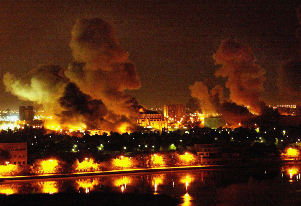 Seven evenly spaced blazes are reflected in the waters of the Tigris during the night-time bombing of Baghdad.