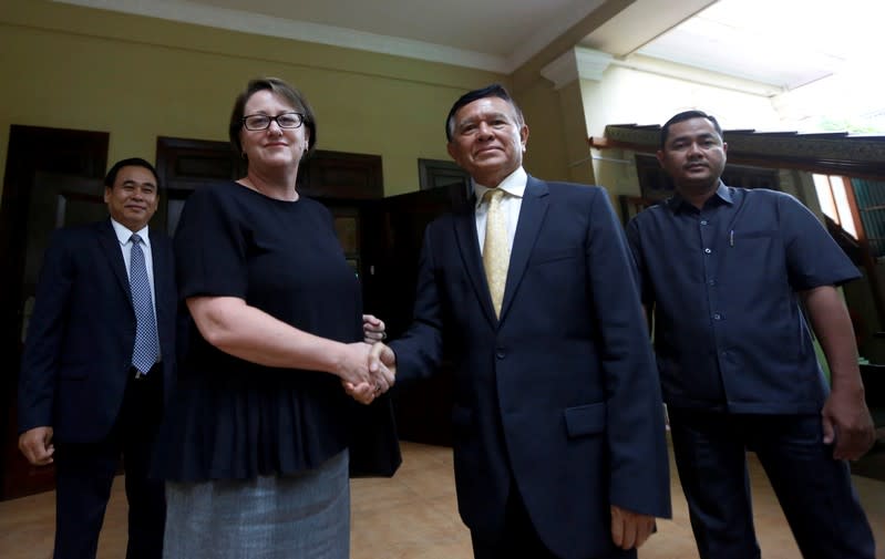 Leader of the Cambodia National Rescue Party (CNRP) Kem Sokha shakes hands with Australian Ambassador to Cambodia Angela Corcoran at his home in Phnom Penh