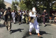 Taliban soldiers walk towards Afghans shouting slogans, during an anti-Pakistan demonstration, near the Pakistan embassy in Kabul, Afghanistan, Tuesday, Sept. 7, 2021. (AP Photo/Wali Sabawoon)