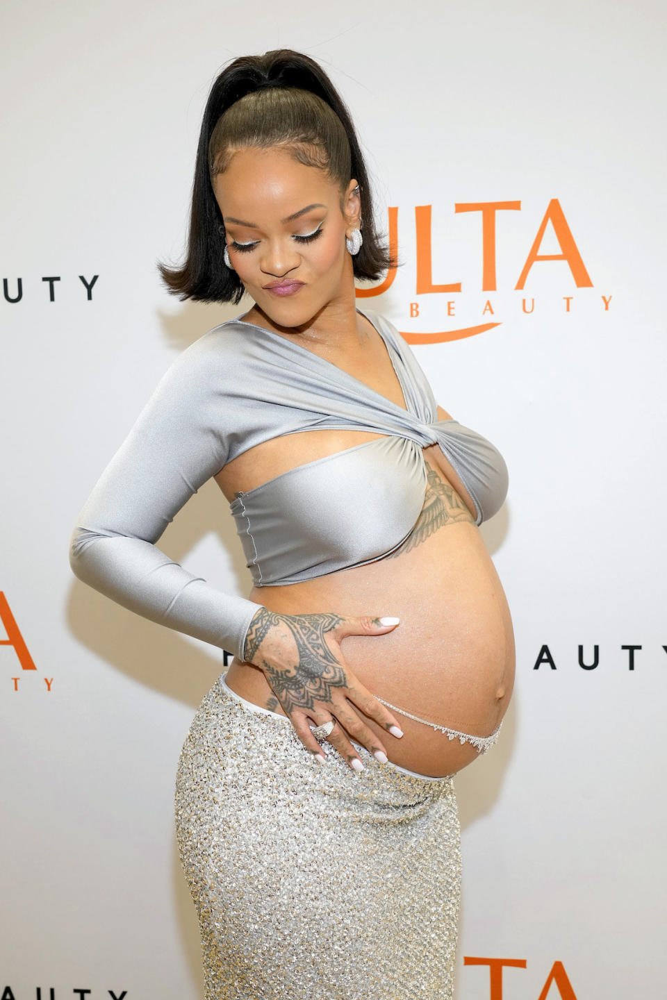 A pregnant Rihanna on the red carpet with a bare midriff