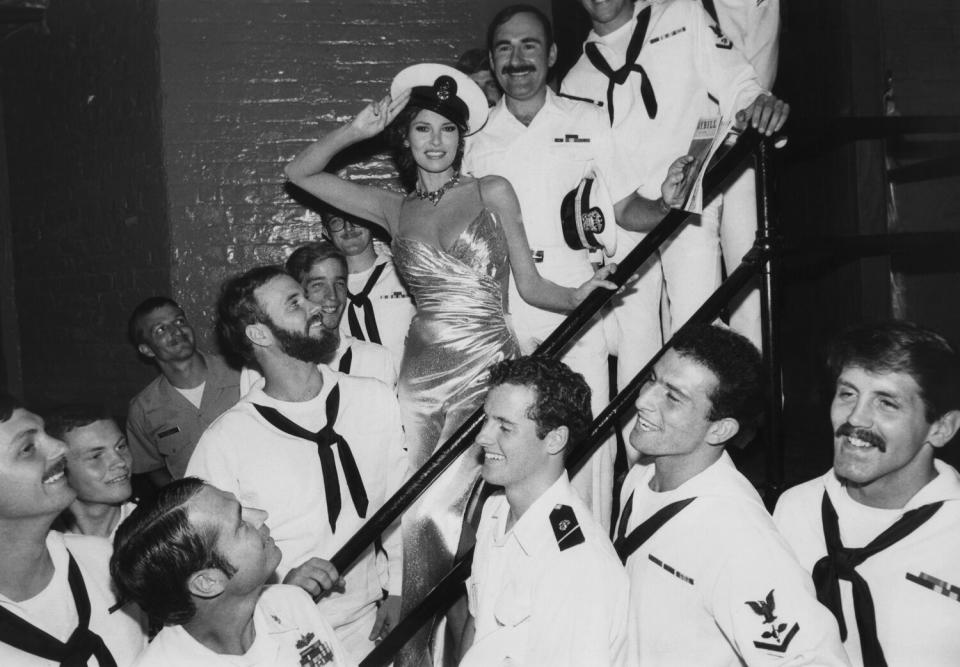 Raquel Welch, starring in Broadway's 'Woman of the Year,' poses with sailors