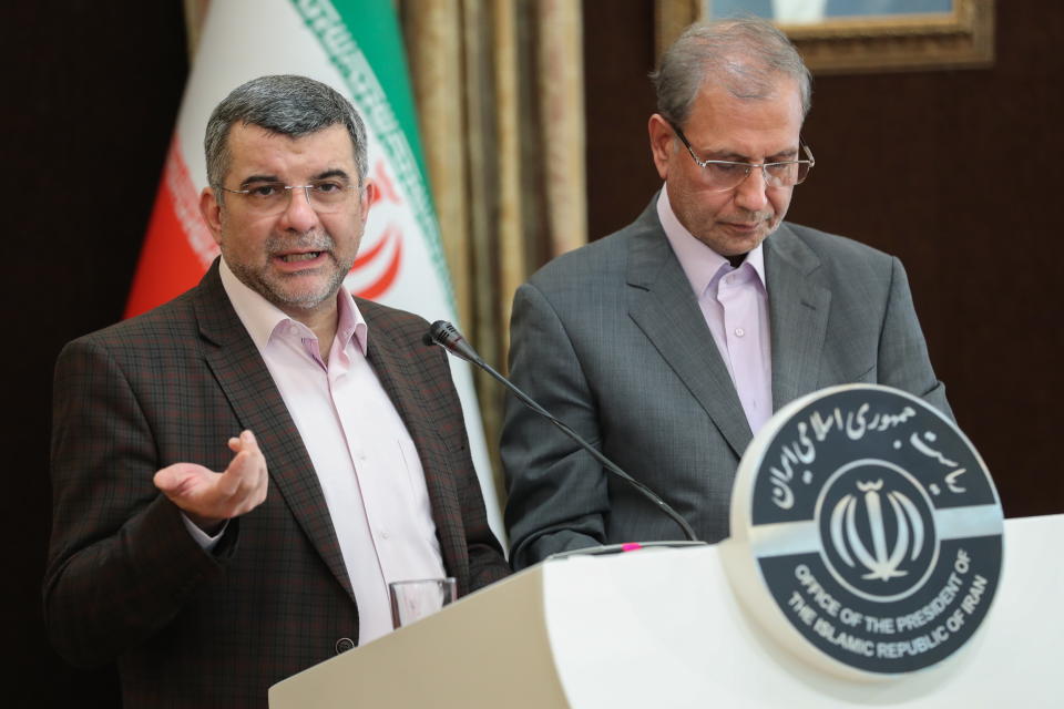 Iranian health minister Iraj Harirchi, left, standing next to the Iranian government spokesman Ali Rabie, right, during a presser in Tehran. Source: AAP