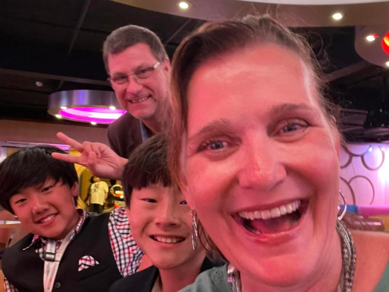 jill and her family posing for a selfie on a disney cruise