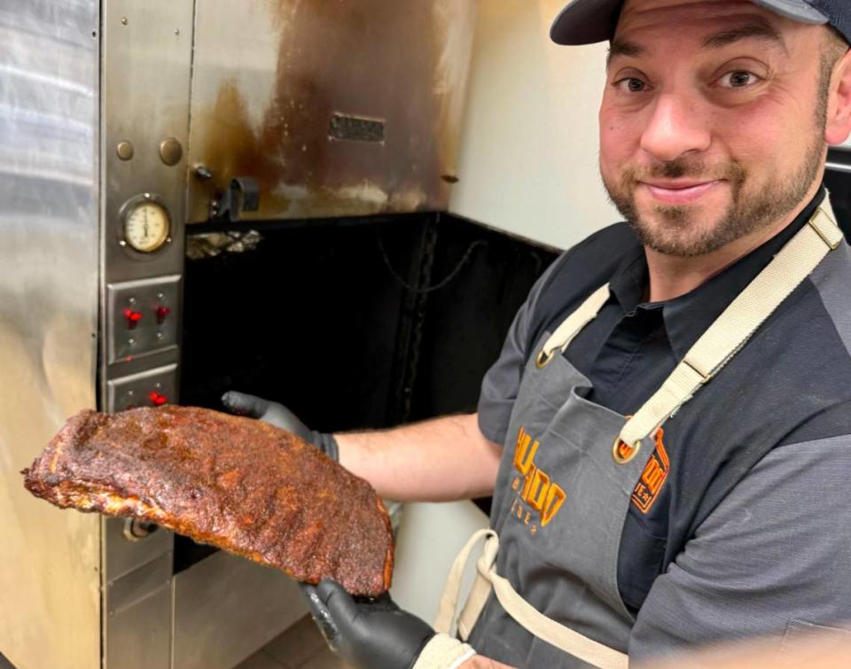 Brandon Hurtado shows ribs ready for the new Hurtado Barbecue location in Mansfield.