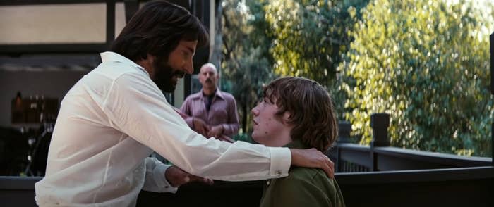 Cooper puts his hand on Cooper Hoffman's shoulders in a scene from the film