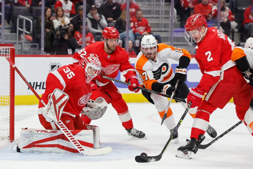 Detroit Red Wings defenseman Olli Maatta (2) clears the puck from in front of goaltender Ville Husso (35) in the first period at Little Caesars Arena in Detroit on Saturday, Jan. 21, 2023.