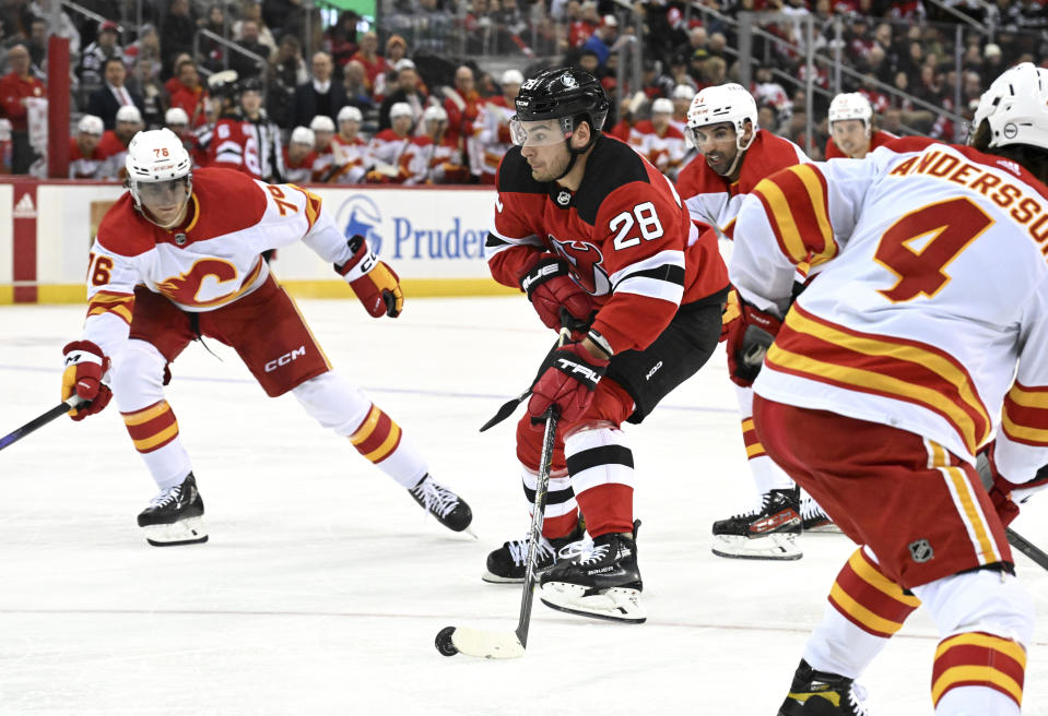 New Jersey Devils right wing Timo Meier (28) skates toward the net as Calgary Flames center Martin Pospisil (76) defends during the second period of an NHL hockey game Thursday, Feb. 8, 2024, in Newark, N.J.(AP Photo/Bill Kostroun)