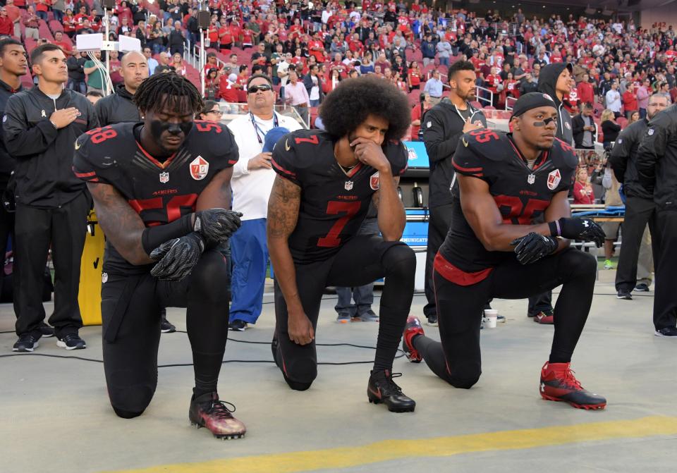 San Francisco 49ers' Eli Harold, Colin Kaepernick and Eric Reid kneel in protest during the playing of the national anthem before a NFL game against the Arizona Cardinals at Levi's Stadium on Oct 6, 2016.