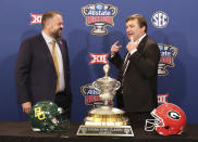Georgia head coach Kirby Smart, right, tells Baylor head coach Matt Rhule you have to remember to smile during their photo opportunity with the Sugar Bowl trophy during an during an NCAA college football press conference, Tuesday, Dec. 31, 2019, in New Orleans. (Curtis Compton/Atlanta Journal-Constitution via AP)