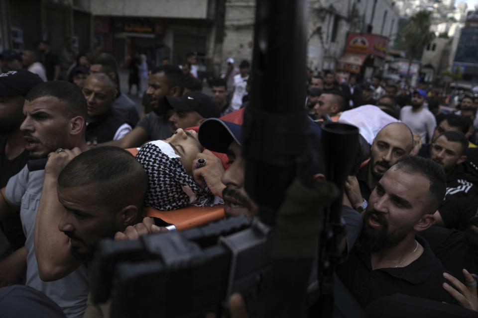 Palestinian mourners carry the body of Khalil Yahya Anis during his funeral in the West Bank city of Nablus, Thursday, June 15, 2023. The Palestinian Health Ministry said the 20-year-old man was shot in the head by Israeli forces. The Israeli military said troops operating in the city came under fire and fired back. (AP Photo/Nasser Nasser)