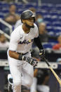 Miami Marlins' Bryan De La Cruz (77) hits a triple to right field during the sixth inning of a baseball game against the Washington Nationals, Wednesday, Sept. 22, 2021, in Miami. (AP Photo/Marta Lavandier)