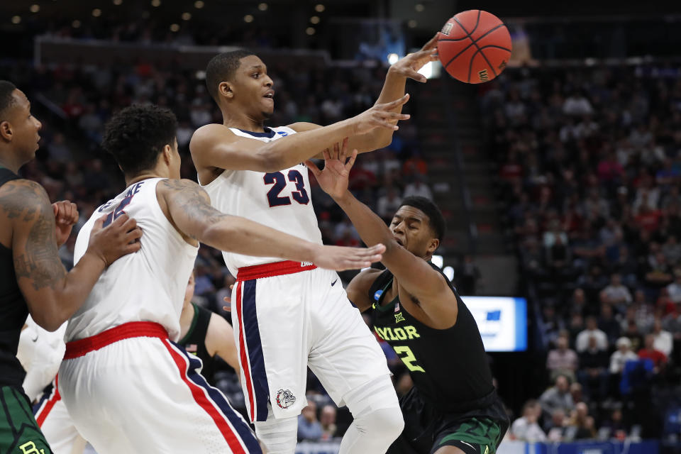 <p>Gonzaga guard Zach Norvell Jr. (23) passes against Baylor guard Jared Butler, right, during the first half of a second-round game in the NCAA men’s college basketball tournament Saturday, March 23, 2019, in Salt Lake City. (AP Photo/Jeff Swinger) </p>