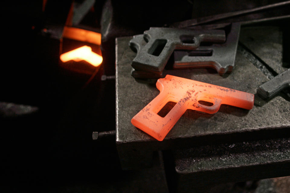 FILE- In this Dec. 19, 2006, file photo, a molten hot first cut of a model 1911 pistol sits on a shelf between a press and cooling conveyor after being rejected by quality control at the Smith & Wesson factory in Springfield, Mass. Two of the hottest trends in investing are working in tandem to steer billions of dollars toward companies seen as the best corporate citizens. The sustainable investing field in its early days attracted investors by avoiding so-called “sin stocks”-- gun makers, cigarette manufacturers, etc. (AP Photo/Charles Krupa, File)