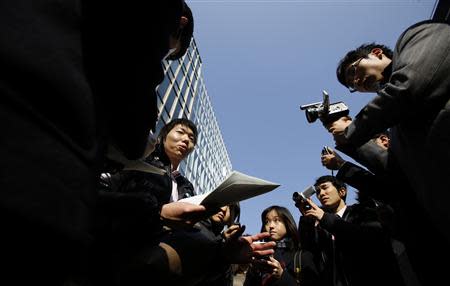 A Japanese investor (C) speaks to the media as he protests against Mt. Gox, in front of the building where the digital marketplace operator was formerly housed in Tokyo February 26, 2014. REUTERS/Toru Hanai