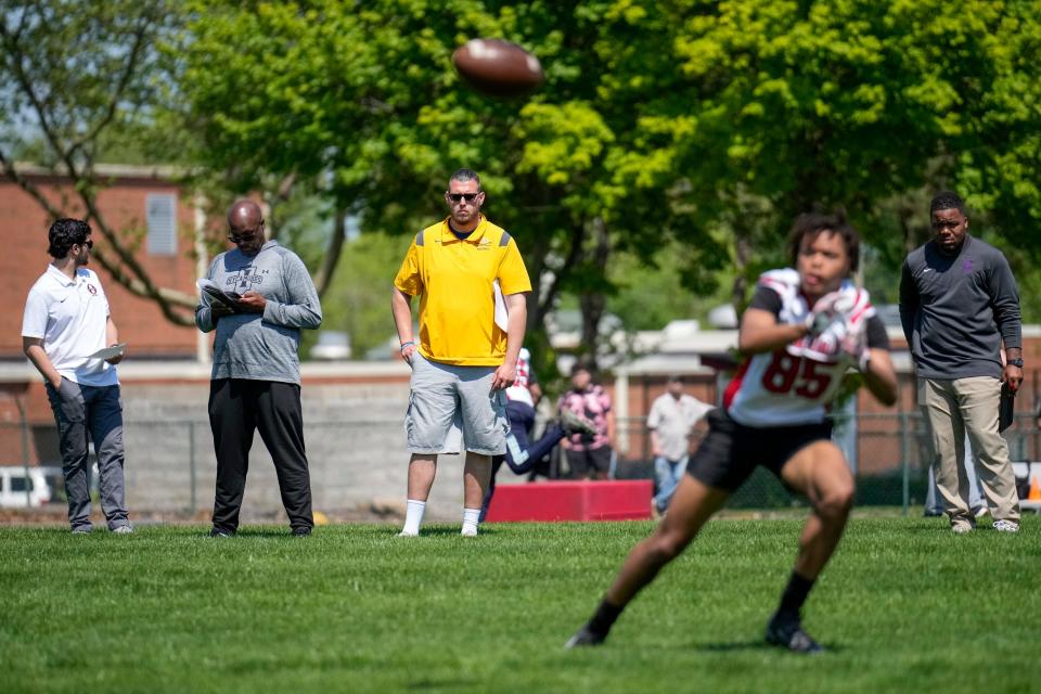 May 10, 2023; Columbus, Ohio, USA;  College football coaches from across the country watch Marion-Franklin sophomore wide receiver Dawayne Galloway (85) take part in a catching drill during the Columbus City League Prospect Showcase organized by Darren Jr. Recruiting Service at Marion-Franklin High School. 