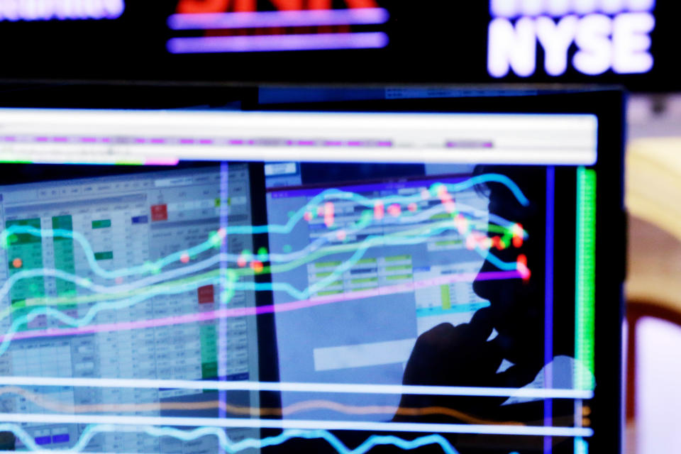 FILE - In this Monday, Jan. 11, 2016, file photo, specialist Anthony Rinaldi is silhouetted on a screen at his post on the floor of the New York Stock Exchange. A smoother ride for stock investors sounds like a no-brainer given this year’s big swings for the stock market, but the “low-volatility” funds pitched by the investment industry come with their own risks. (AP Photo/Richard Drew, File)