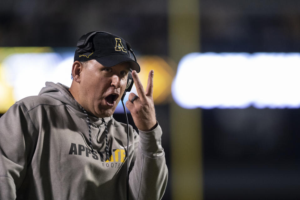 Appalachian State coach Shawn Clark gestures during the first half of the team's NCAA college football game against Coastal Carolina on Wednesday, Oct. 20, 2021, in Boone, N.C. (AP Photo/Matt Kelley)