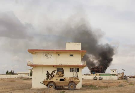 Smoke billows from a building after a Taliban attack in Gereshk district of Helmand province, Afghanistan March 9, 2016. REUTERS/Abdul Malik