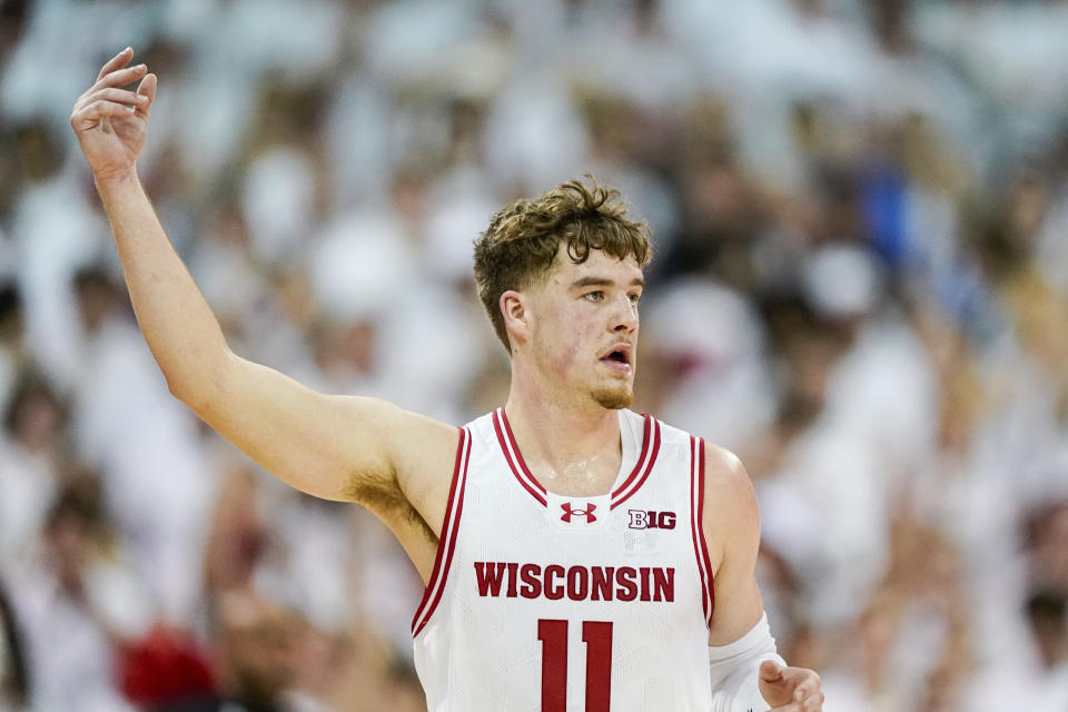 Wisconsin's Max Klesmit (11) signals after hitting a three-point basket against Marquette during the first half of an NCAA college basketball game, Saturday, Dec. 2, 2023, in Madison, Wis. (AP Photo/Andy Manis)