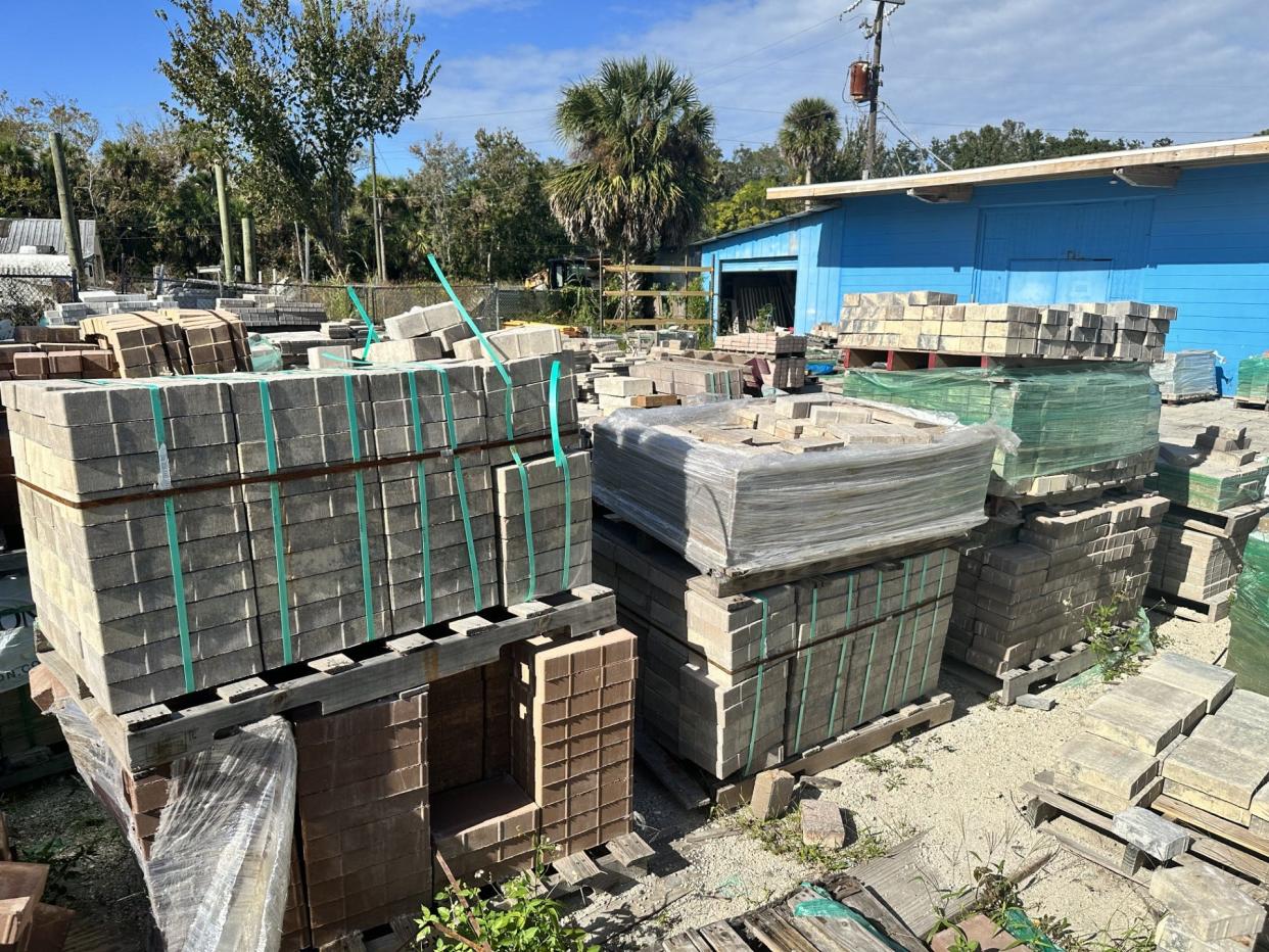 A yard at Serene Pavers & Stonescapes Inc., New Smyrna Beach, still features stacks of unused stone pavers after the business closed without completing jobs for which some customers paid 50% deposits.