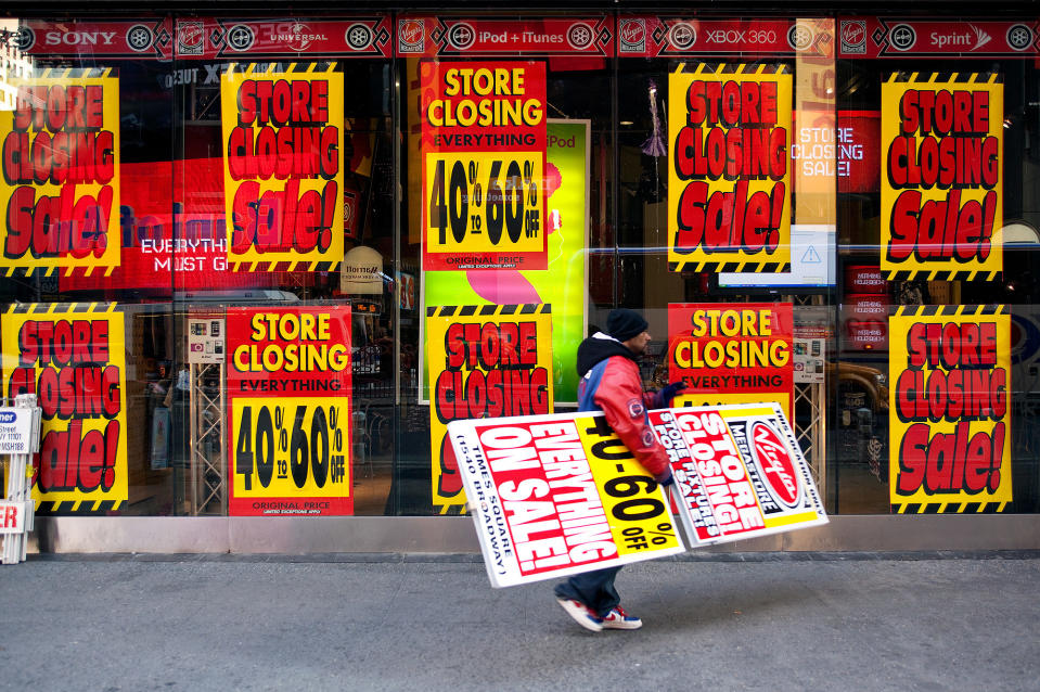 A man advertises the closing of the Virgin Megastore in Times Square in New York City on March 17, 2009.