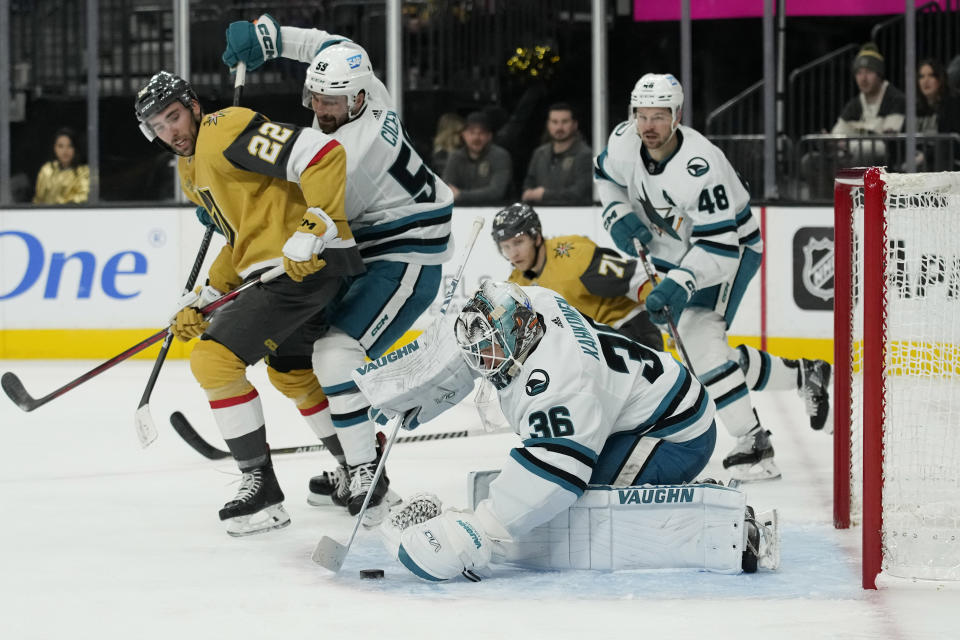 San Jose Sharks goaltender Kaapo Kahkonen (36) covers the puck against the Vegas Golden Knights during the second period of an NHL hockey game Thursday, Feb. 16, 2023, in Las Vegas. (AP Photo/John Locher)